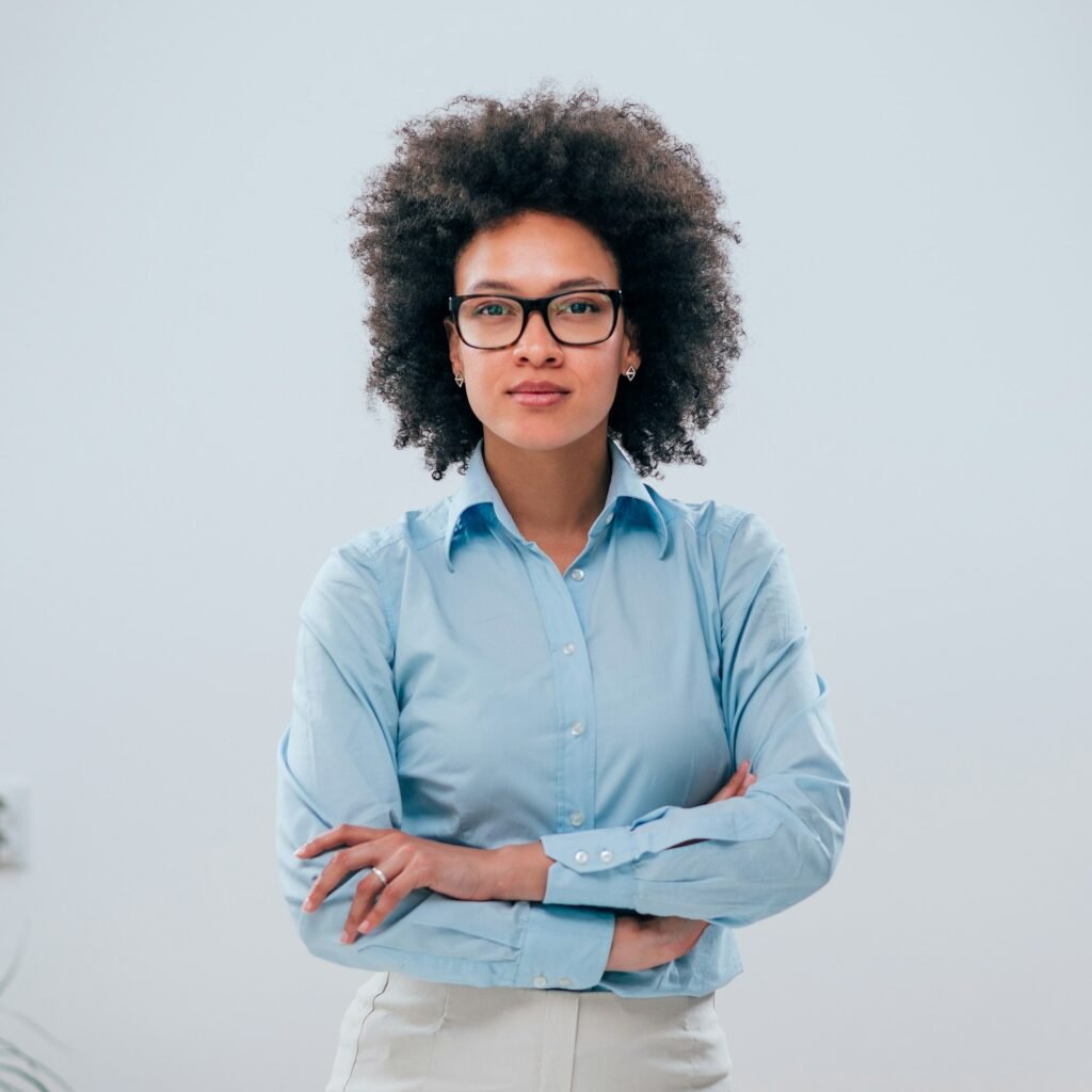 portrait of a confident businesswoman with curly hair on isolated background
